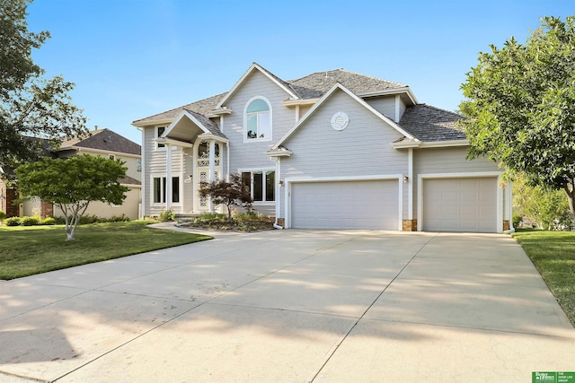 view of front property with a front yard and a garage