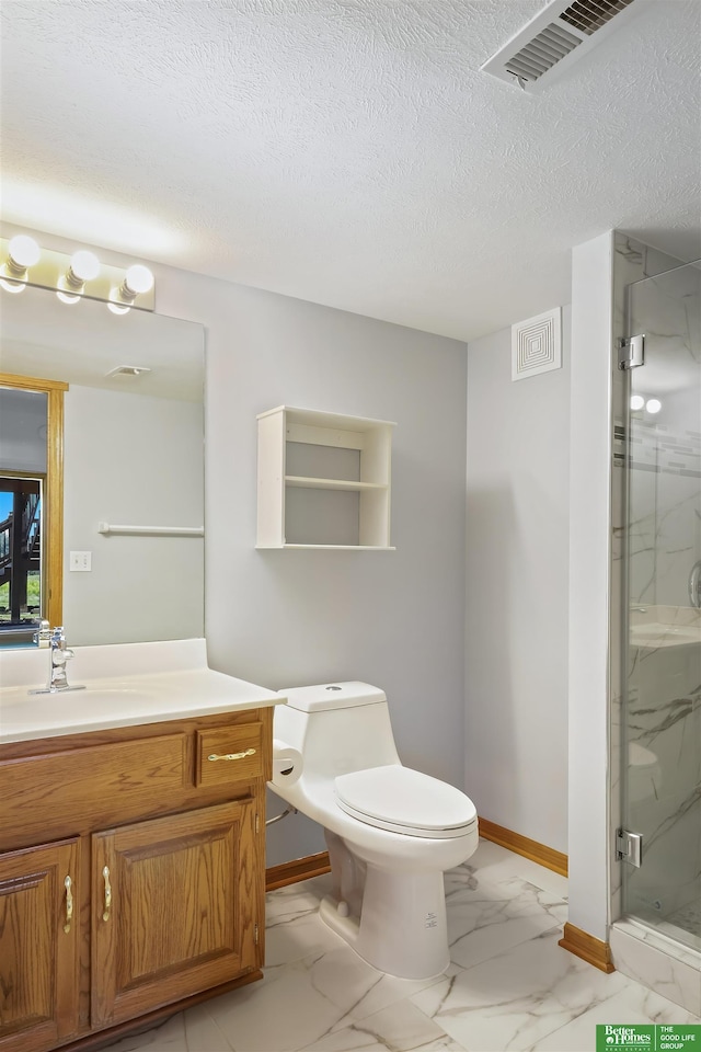 bathroom featuring toilet, vanity, a textured ceiling, and walk in shower