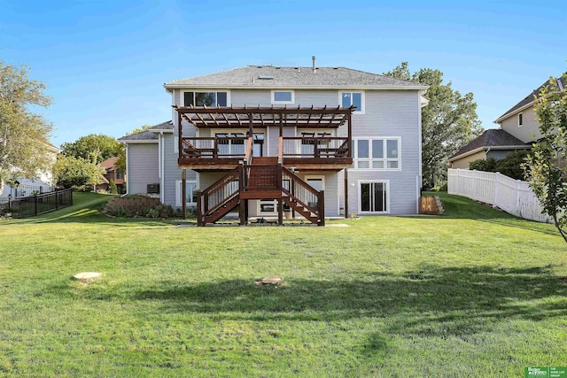 back of property with a pergola, a deck, and a lawn