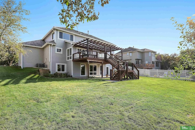 back of property featuring a pergola, a wooden deck, and a yard