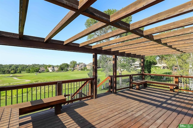 wooden deck with a pergola and a lawn