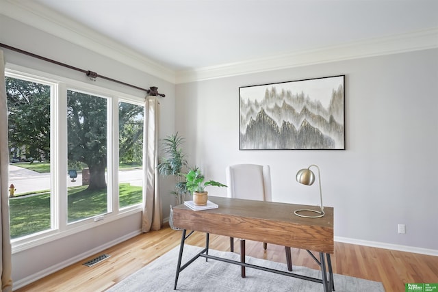 home office featuring crown molding and light hardwood / wood-style flooring