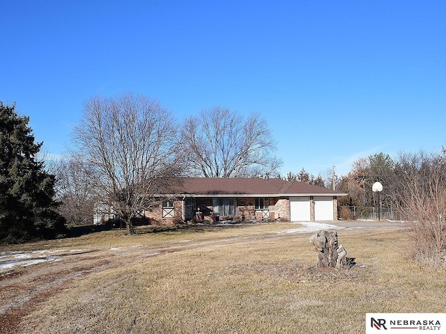 view of front of house featuring a garage and a front lawn