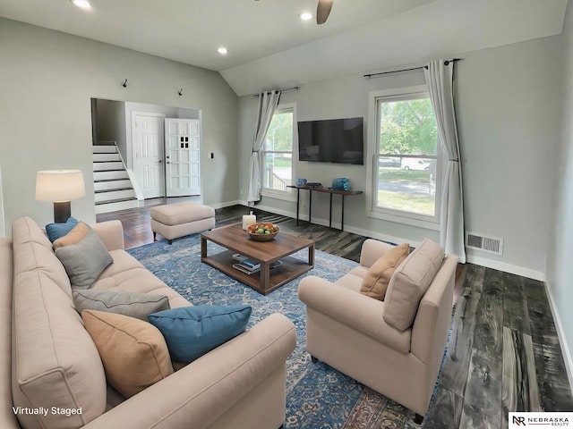 living room with wood-type flooring and vaulted ceiling