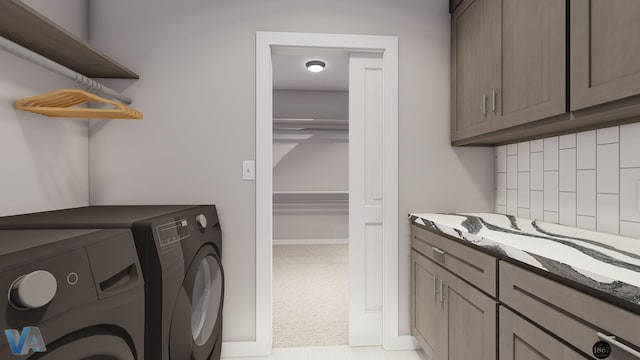 laundry room featuring cabinets, light carpet, and washer and clothes dryer