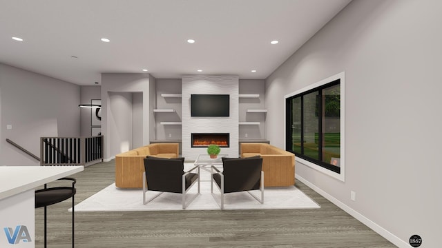 living room with built in shelves, a large fireplace, and wood-type flooring