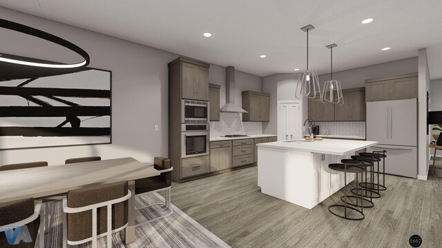 kitchen featuring appliances with stainless steel finishes, backsplash, wall chimney exhaust hood, hanging light fixtures, and an island with sink