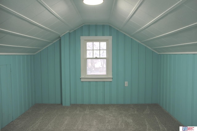 bonus room featuring vaulted ceiling and carpet flooring