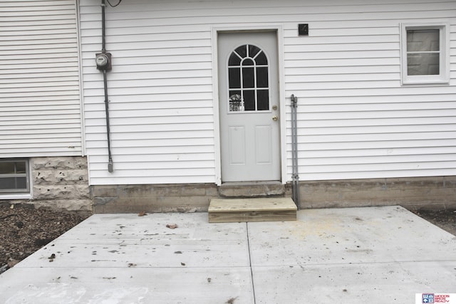 entrance to property featuring a patio