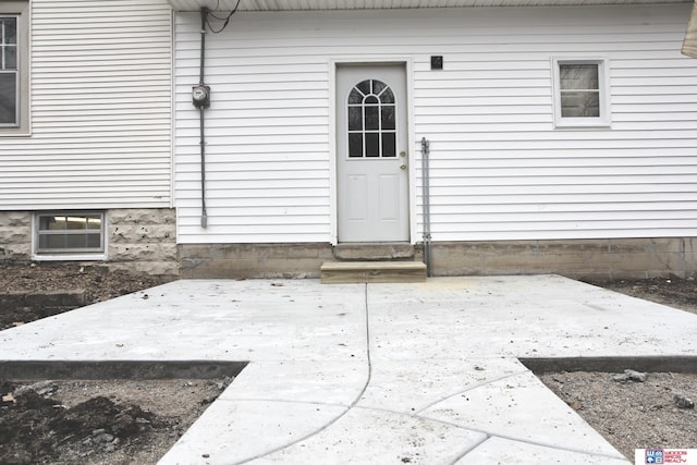 property entrance featuring a patio