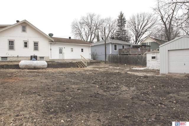 back of property featuring a garage and an outdoor structure