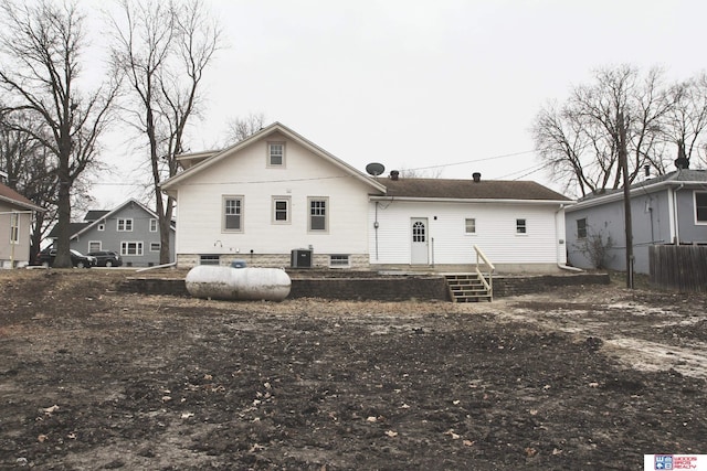 rear view of house with central AC unit