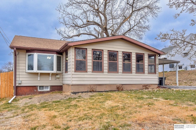 rear view of property with a yard