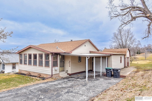 view of front of home featuring a garage and a sunroom