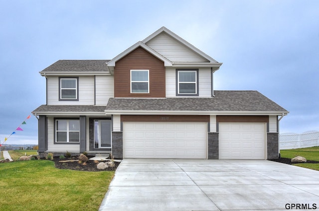 view of front of house featuring a garage and a front lawn