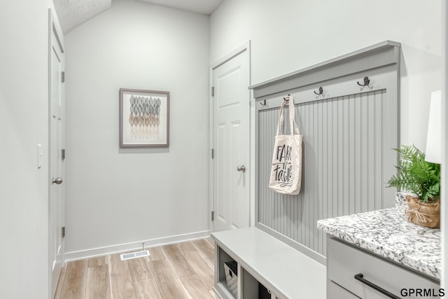 mudroom featuring a textured ceiling and light wood-type flooring