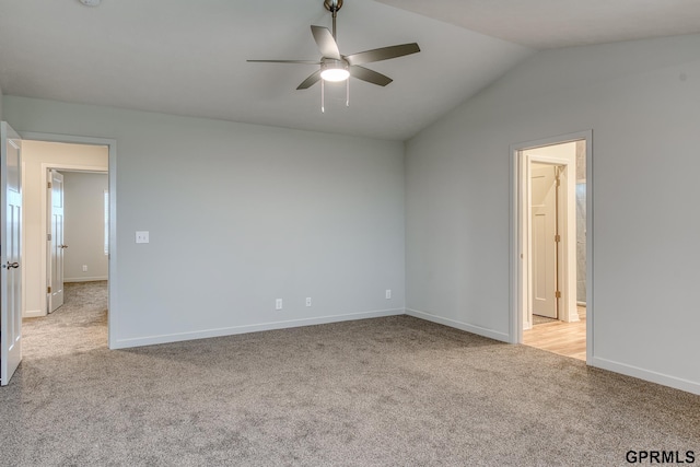 carpeted empty room with vaulted ceiling and ceiling fan