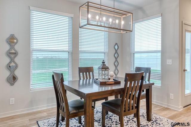 dining area featuring a notable chandelier and light hardwood / wood-style floors