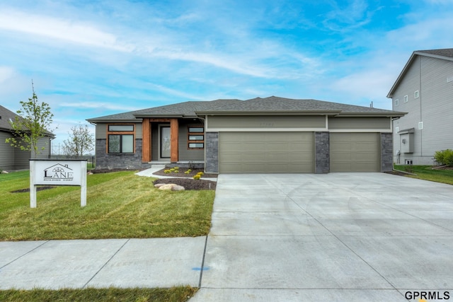 prairie-style house with a front yard and a garage