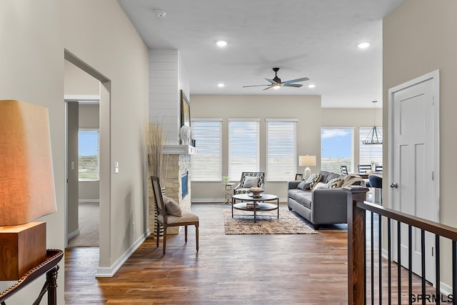 living room featuring dark hardwood / wood-style flooring, plenty of natural light, and ceiling fan