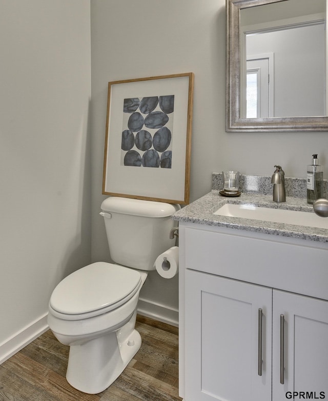 bathroom featuring hardwood / wood-style floors, vanity, and toilet