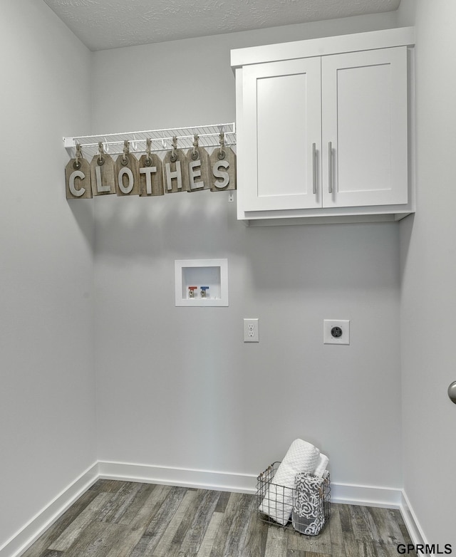 clothes washing area with cabinets, hookup for an electric dryer, dark hardwood / wood-style flooring, hookup for a washing machine, and a textured ceiling