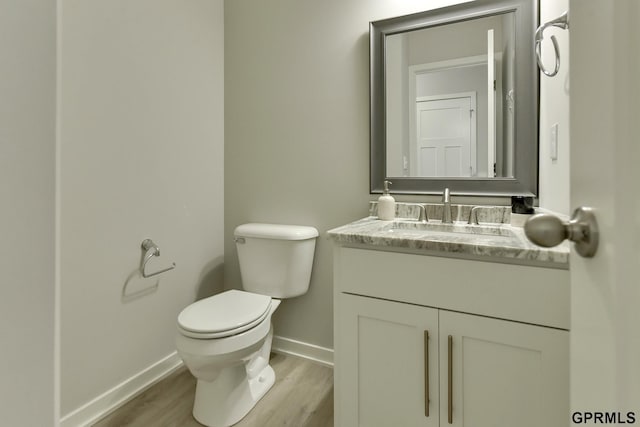 bathroom featuring hardwood / wood-style floors, vanity, and toilet