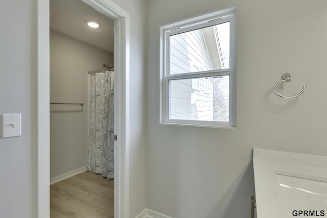 bathroom with a shower with shower curtain, vanity, and hardwood / wood-style flooring