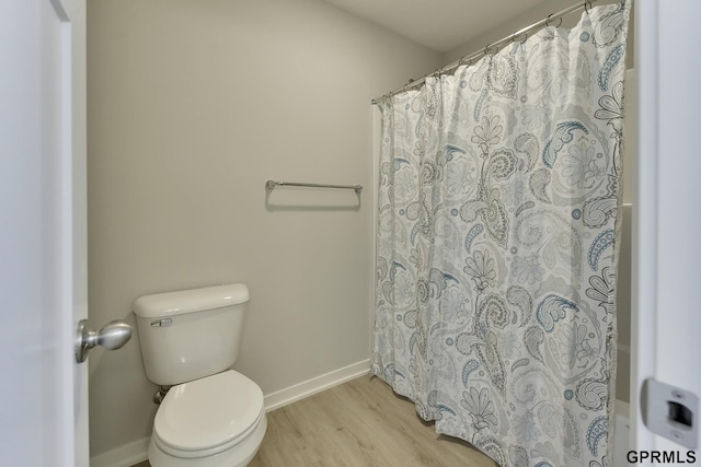 bathroom featuring hardwood / wood-style floors and toilet