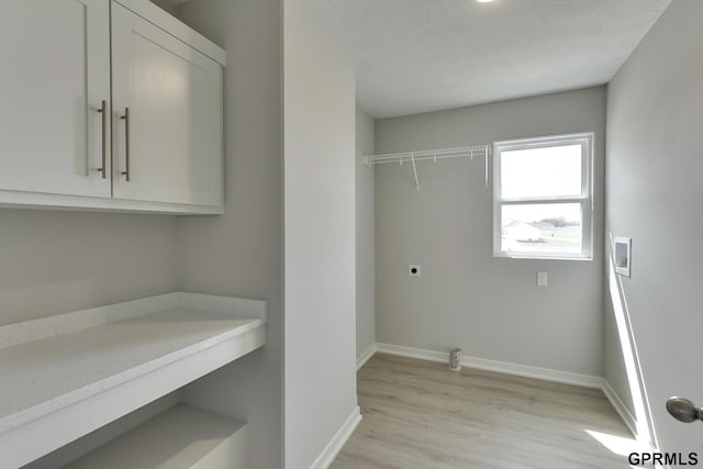 laundry room featuring cabinets, washer hookup, light wood-type flooring, and hookup for an electric dryer