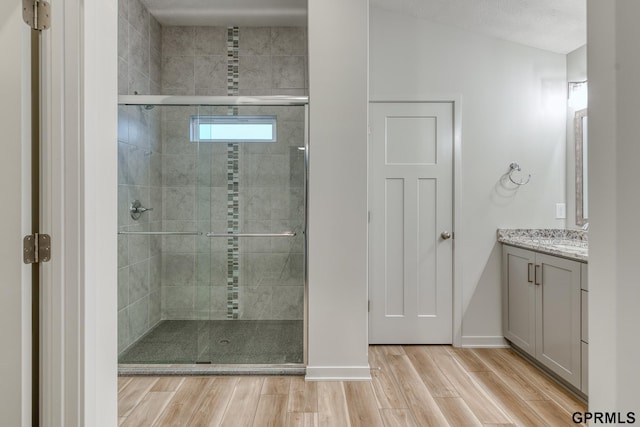 bathroom with vanity and a shower with shower door