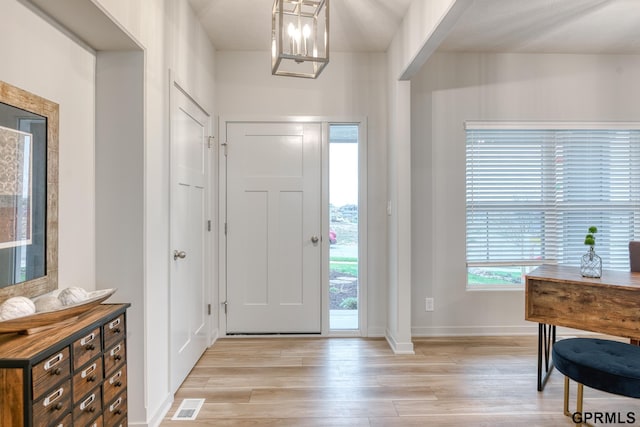 foyer featuring a notable chandelier and light wood-type flooring