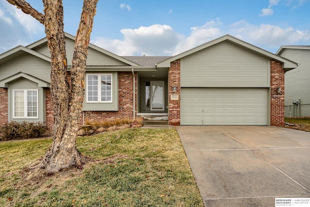 single story home with a garage and a front yard