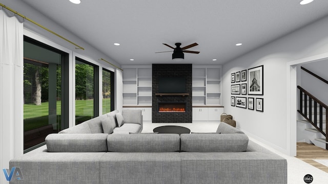 living room featuring built in features, light wood-type flooring, a brick fireplace, and ceiling fan