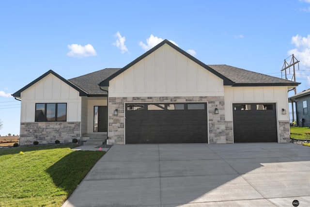 modern farmhouse featuring a front lawn and a garage