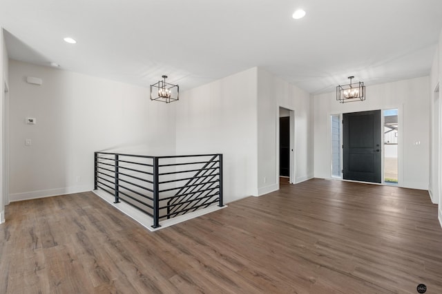 foyer entrance featuring hardwood / wood-style floors and an inviting chandelier