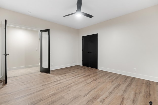 unfurnished bedroom featuring ceiling fan, a closet, and light hardwood / wood-style floors