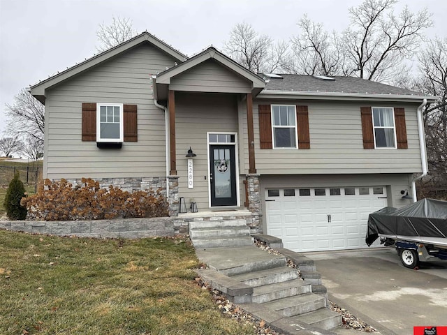 view of front of property featuring a garage and a front lawn