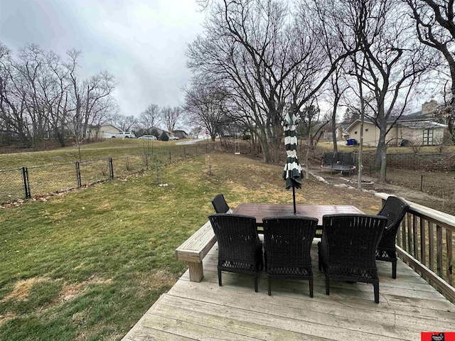 deck featuring a lawn and a trampoline