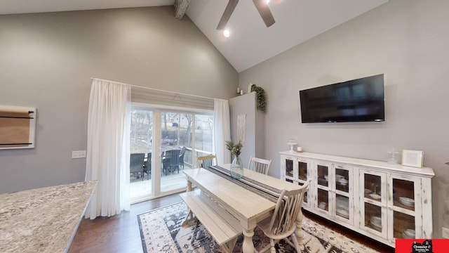 dining area with ceiling fan, dark hardwood / wood-style floors, beam ceiling, and high vaulted ceiling