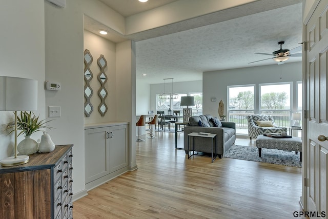 living room featuring ceiling fan and light wood-type flooring