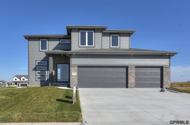 view of front of home featuring a garage and a front lawn