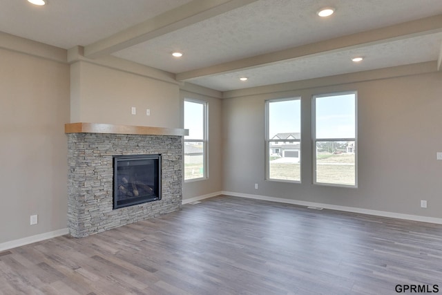 unfurnished living room featuring a fireplace and wood-type flooring