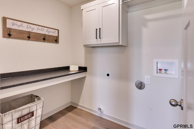 laundry room with cabinets, hookup for a washing machine, light hardwood / wood-style flooring, and hookup for an electric dryer