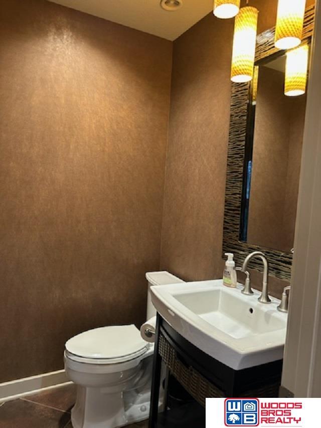 bathroom with tile patterned flooring, vanity, and toilet