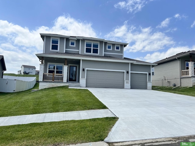 view of front of house with a front yard, a porch, and a garage