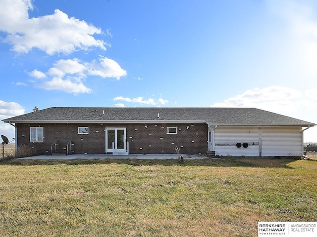 back of property with a lawn and a patio area