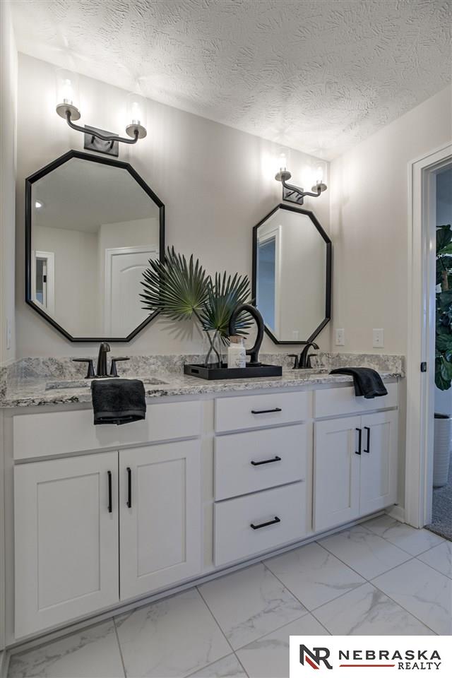 bathroom featuring vanity and a textured ceiling