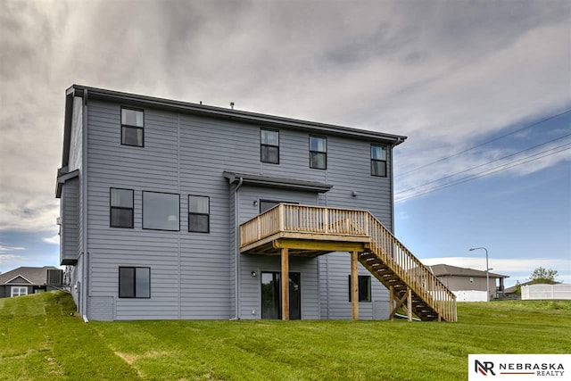 rear view of property with a lawn and a wooden deck