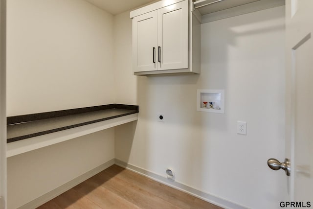 clothes washing area with hookup for an electric dryer, cabinets, light wood-type flooring, and hookup for a washing machine